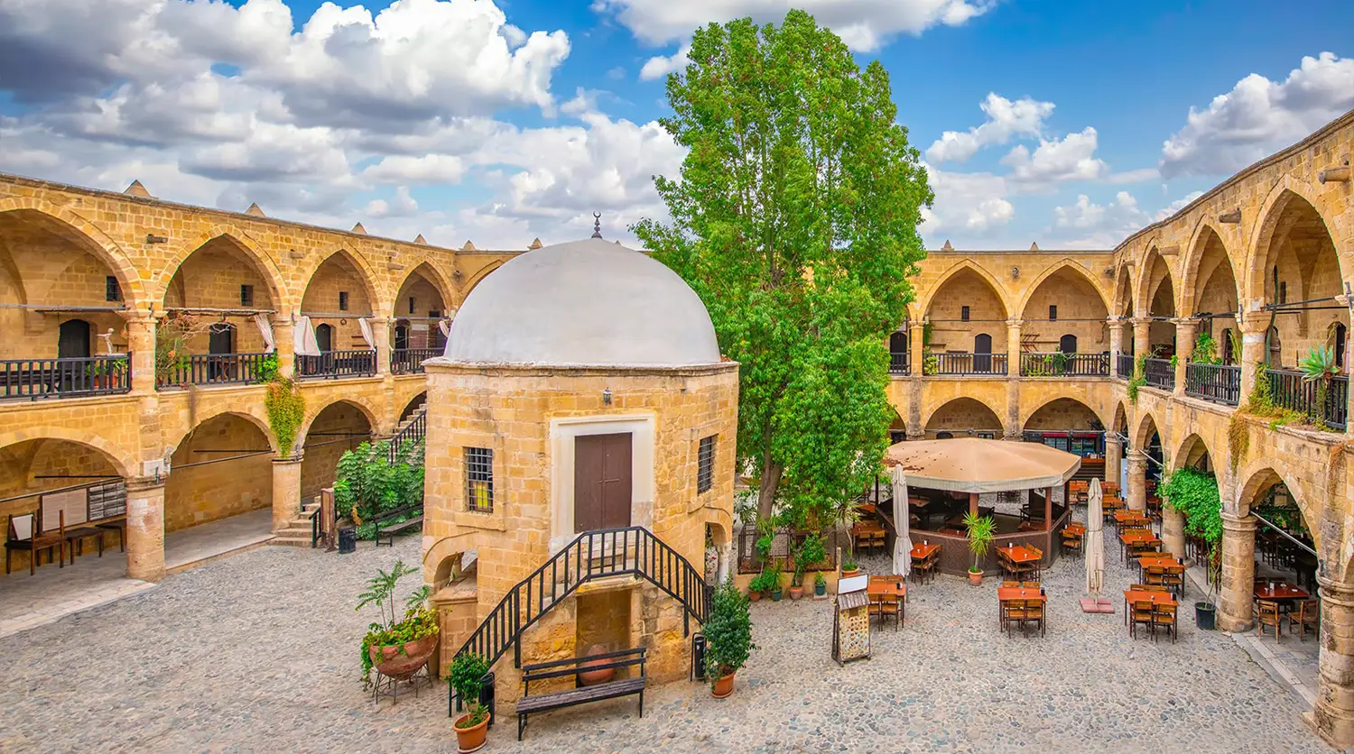 The arcaded courtyard of Büyük Han in Nicosia with its domed mosque on pillars
