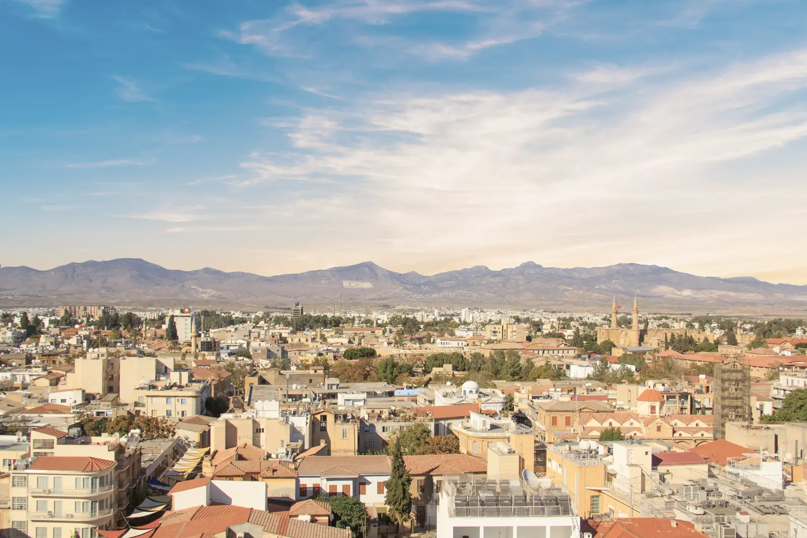 Nicosia rooftops with the twin minarets of Selimiye Mosque and the mountains behind